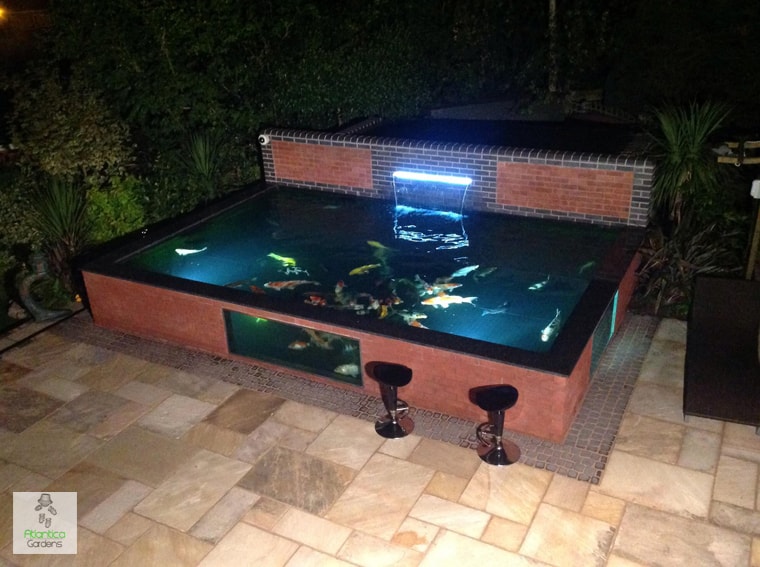 Large koi pond with pond window frame and glass